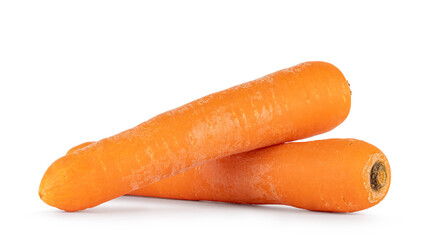 Two carrots laying down side ways, one on top of the other. Isolated on a white background