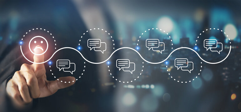 Negative customer feedback, customer compliants, compliant management concept. Touching screen on a sad face icon among chat icons, dissatisfaction, poor customer experience and service evaluation.
