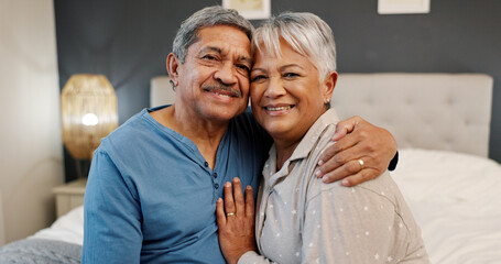Fototapeta premium Bedroom, senior couple and portrait with hug for support, bonding together and commitment in marriage. Old people, man and woman with smile for anniversary, connection and love in retirement at home