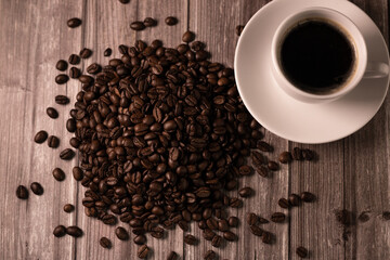 Coffee background. Coffee on top. Coffee beans and a cup of espresso