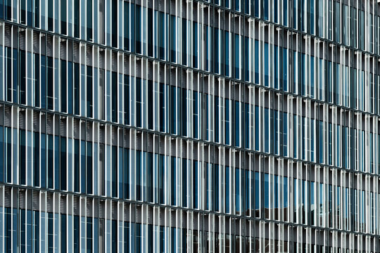 Blue-toned vertical louvers and glass on contemporary urban facade. Clean, modern and ideal for commercial projects related to architecture and real estate.
