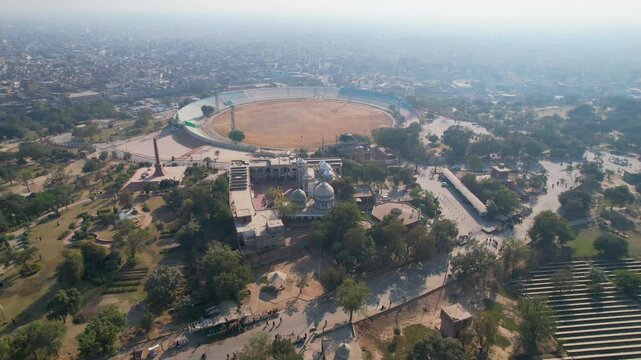 Multan Cricket Stadium beside historic architecture and dense urban sprawl. Multan