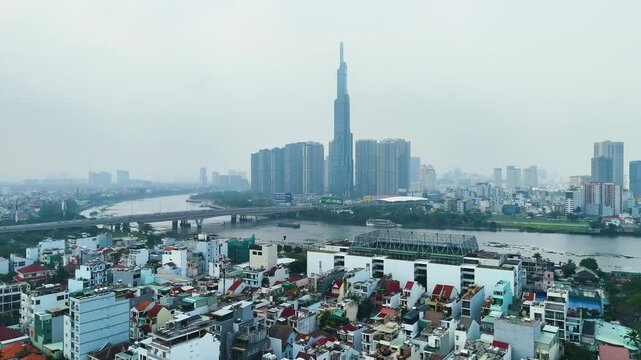 Aerial: Landmark 81 supertall skyscraper during the day with pollution in Ho Chi Minh City, Vietnam, establishing drone shot