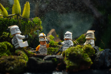 Naklejka premium Depok, Indonesia - April 1, 2025: Lego toys photography, 1st phase clone troopers in dark forest covered with moss, with bokeh background