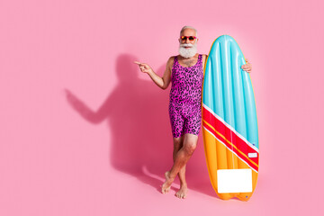 Photo of funny grandfather wear swimsuit summer vacation resort surfing empty space isolated on pink color background