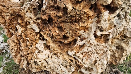 Spongy appearance of a rock with large holes