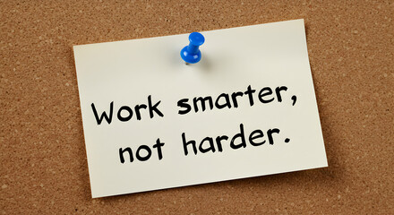 Work Smarter not Harder Motivational Note Pinned on Brown Cork Board for Time Management and Success in a Well Lit Office