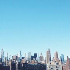 Clear Daytime City Skyline with Blue Sky and Various Buildings
