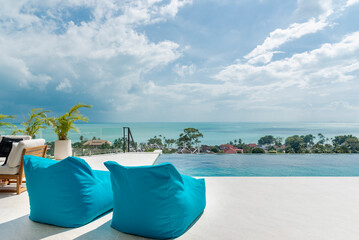 Happy vacation travel landscape, luxury beach resort hotel, swimming pool, relaxing beach chairs, palm trees, bright blue sky, summer seaside island, relaxing mood, travel, vacation, background