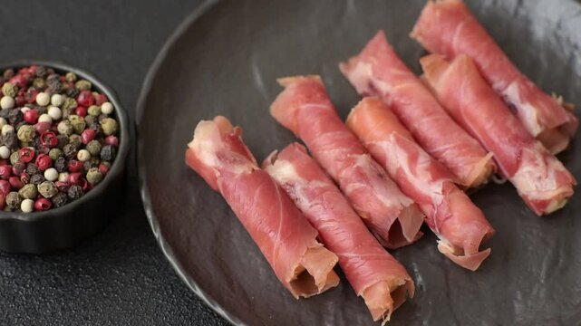 Cheese and meat, jamon or prosciutto rolled into a roll. Antipasti or delicacies for the festive table