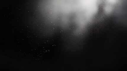 Black matte textured background with floating dust particles illuminated by soft light in the top right corner, creating a deep contrast between black and white. This abstract design emphasizes textur