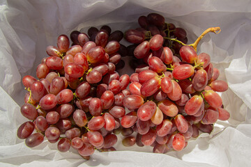 Fresh Red Grapes on White Fabric Background