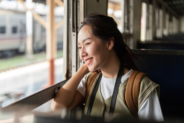Travel and Adventure. A young woman gazing out the window of a train, reflecting on her journey...