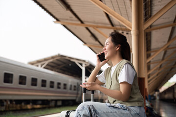 Communication and Travel Planning. A woman chatting on her phone, enjoying her travel experience at...