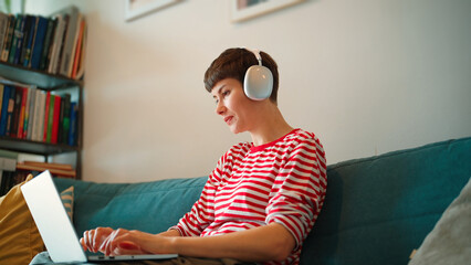 Bottom view of Caucasian woman remotely working or searching something on laptop. Female...