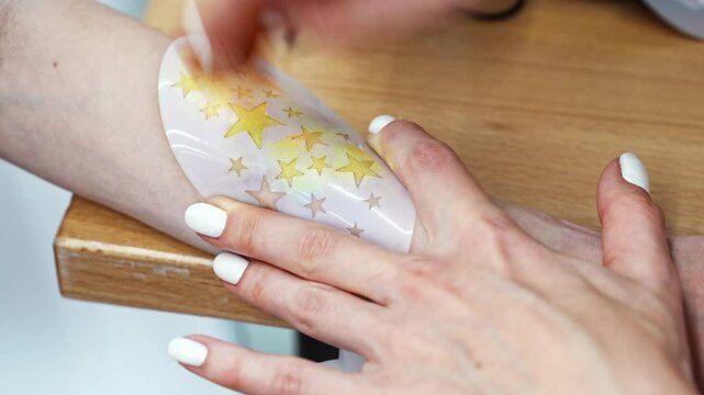 Applying a creative temporary tattoo in a bright studio setting