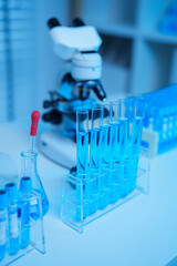 glass flask in chemical science education laboratory with molecular structure in blue background
