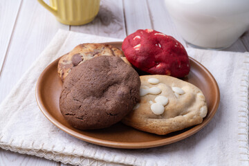 Assorted cookies on a plate over wooden table