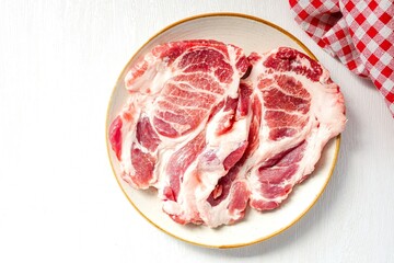 Raw Pork shoulder in ceramic plate on white background