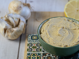 Nice bowl of hummus, a traditional Middle Eastern vegetarian dish made from chickpeas.