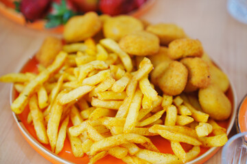 Freshly prepared fries and golden nuggets served on a vibrant plate