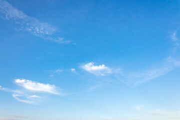 nature backdrop with blue sky and white fluffy clouds in morning light. bright and sunny weather forecast background