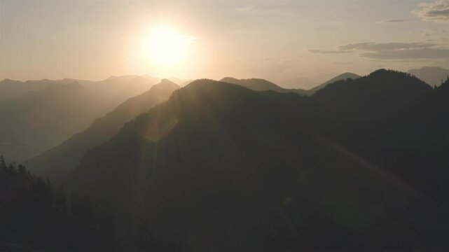Drone aerial video with the Bavarian Alps enlighted by the morning golden hour light
