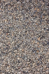 Top Down Vertical View Of Crushed Stone And Gravel Texture. Mix Of Gray, Brown, And Beige Small Rocks Background For Construction Or Pathway.