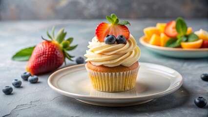 Delightful Vanilla Cupcake Topped with Fresh Berries and a Mint Garnish, Served on a Plate with Additional Fruit