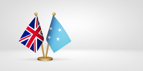 Obraz premium UK vs Micronesia desk flags mockup 3d illustration. Versus flag of United Kingdom of Great Britain