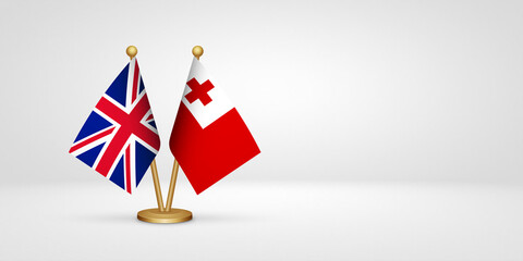 Obraz premium UK vs Tonga desk flags mockup 3d illustration. Versus flag of United Kingdom of Great Britain