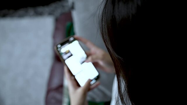 Young woman is obsessed with her smartphone, constantly scrolling through social media feeds, unable to escape the digital vortex