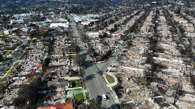 Drone following a car driving through fire devastation in Pacific Palisades, LA