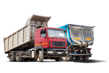 Two heavy construction trucks are parked side by side, ready for rent. The trucks feature large, dump beds ideal for transporting materials in an urban setting.