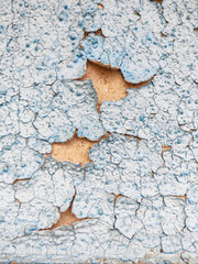 Texture abstract background of blue peeling paint on the old rough surface. Weathered paint cracks on the wall. Repair and restoration. Copy space