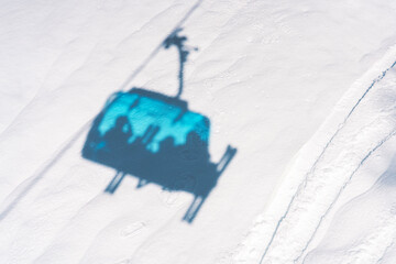 Photo of ski lift shadow on snow