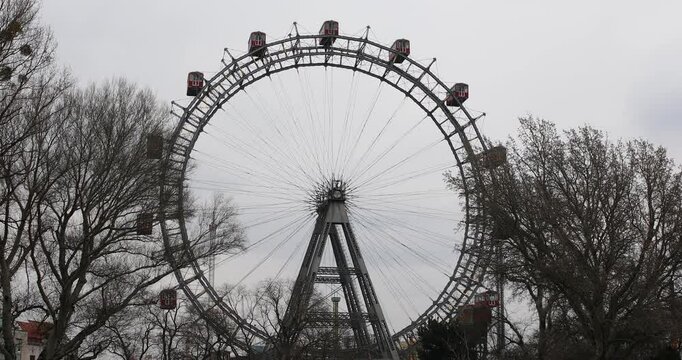 The Vienna Ferris Wheel framed by trees on a cloudy day
