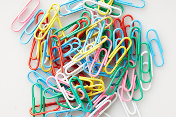 Macro Shot of Assorted Paper Clips Highlighting Colorful Texture and Arrangement on White and...