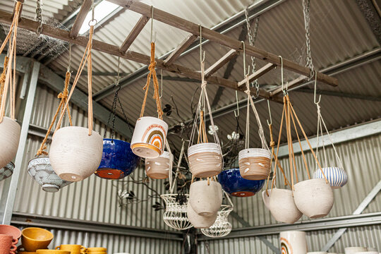 Colourful plant pots for sale in shed at nursery small business