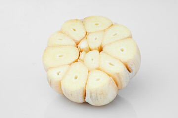 Macro Shot of Garlic Bulb Revealing Close up Texture and Individual Cloves for Culinary Use and Flavor Enhancement on White and Isolated Background