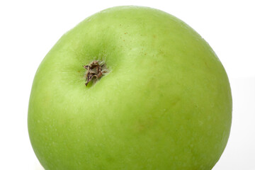 Close up Macro Shot of a Green Apple Showcasing Its Smooth Texture and Vibrant Color on White and Isolated Background