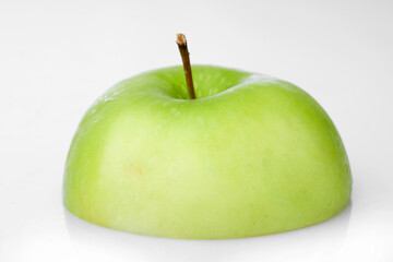 Close up Macro Shot of Half Green Apple Showcasing Smooth Texture and Stem Details