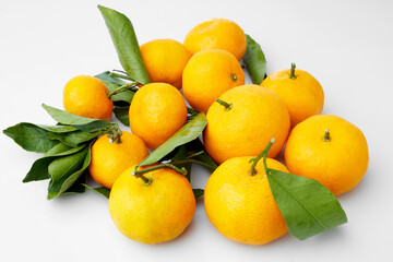 Close up Macro Shot of Vibrant Small Orange Fruit Showcasing Natural Texture and Green Leaves on White and Isolated Background