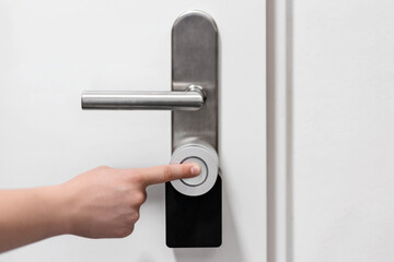 Naklejka premium Door Lock Smart Lock Nuki with Wi-Fi and Matter for Remote Access. Hand Presses Button of Electronic Doors Lock.