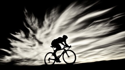 Obraz premium Cyclist silhouette rides with blurred sky background. Dramatic lighting enhances motion and contrast