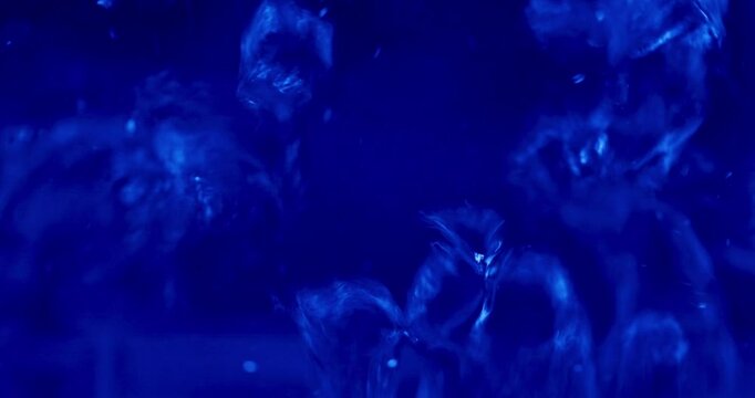 100&deg;C Boiling Point &ndash; Water in Motion Under Blue Glow