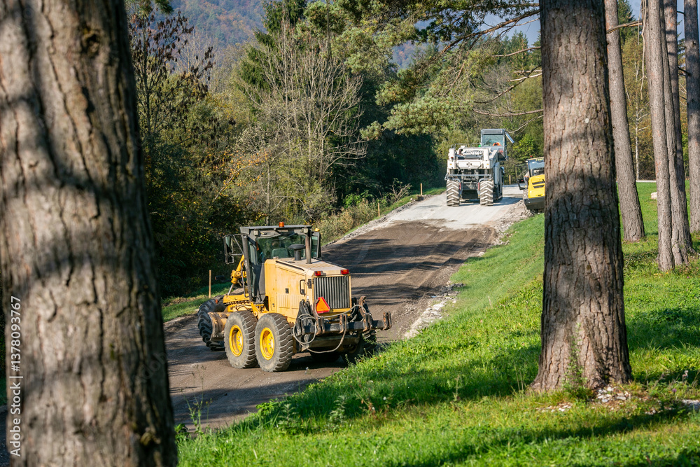 Fototapete preparing the gravel foundation with a motorized grader to level the surface for the new asphalt lay
