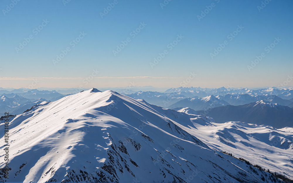 Poster snowy mountain peak reaching towards a clear, bright blue sky. distant mountain range visible in the