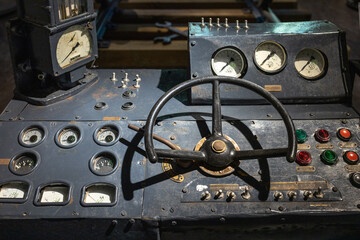 Interior view of a locomotive train cab. Old train control panel. Close-up of machinery