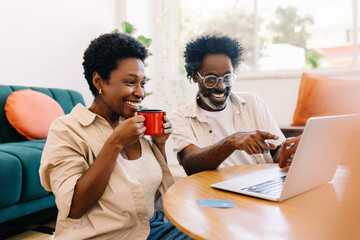Couple watching a funny video together on a laptop